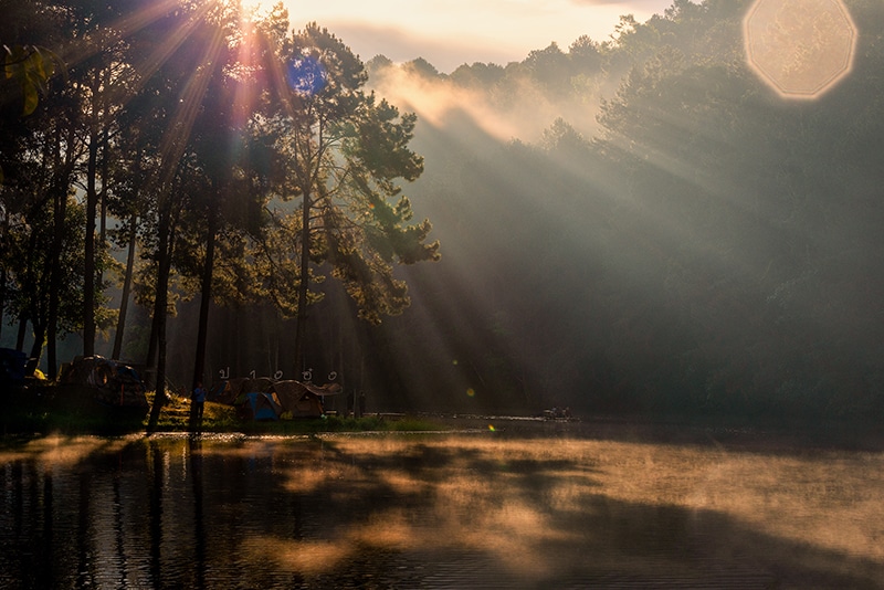 Background blur bright morning light at Pang Ung, Thailand is a tourist place where people come to vacation in the winter. Because the cold causes steam to rise above the surface.And is a popular. Concept Travel